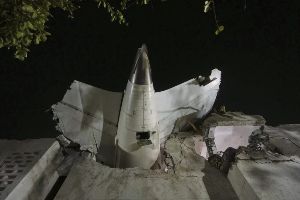 The tail of the crashed Air India flight AI171 is seen stuck in the B.J. Medical College building in Ahmedabad.