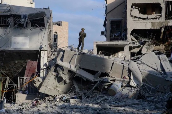 Israeli rescuers search through the rubble of a damaged residential building in Bnei Brak following a missile attack from Iran on June 16, 2025.