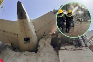The tail of the crashed Air India plane lodged in a damaged building in Ahmedabad, with a circular inset image showing two firefighters spraying water on the smoky wreckage.