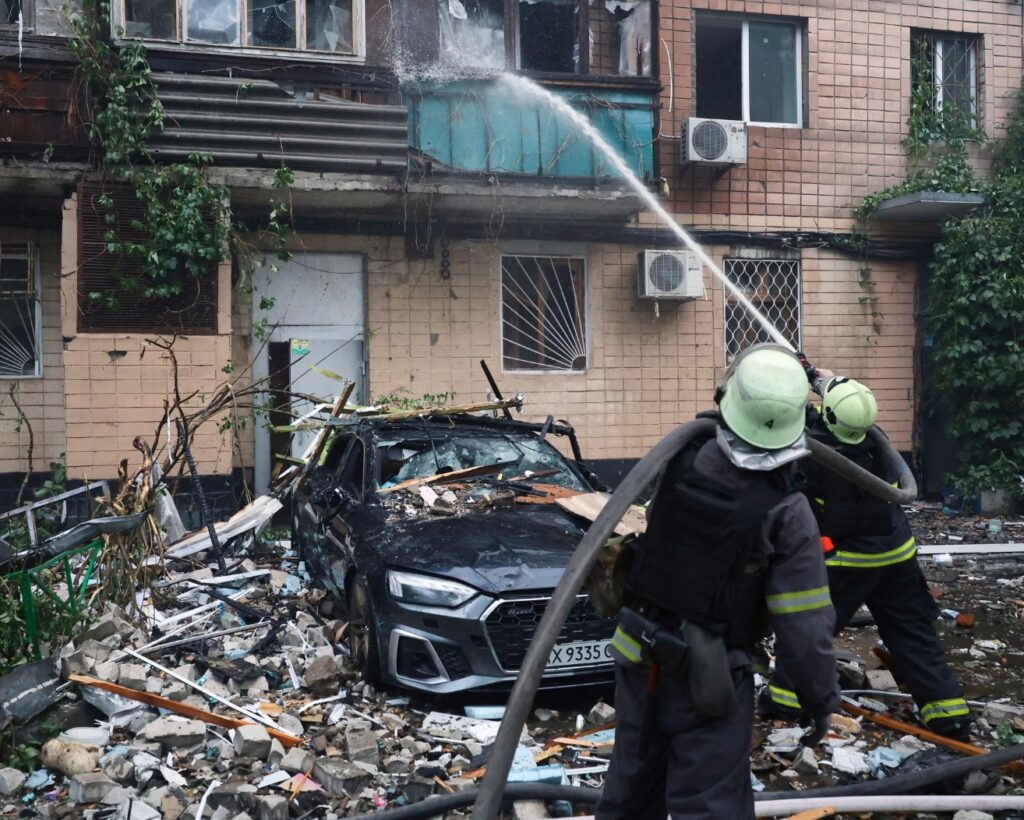 Ukrainian firefighters work to extinguish a blaze in a heavily damaged apartment building in Kharkiv after a Russian missile strike.